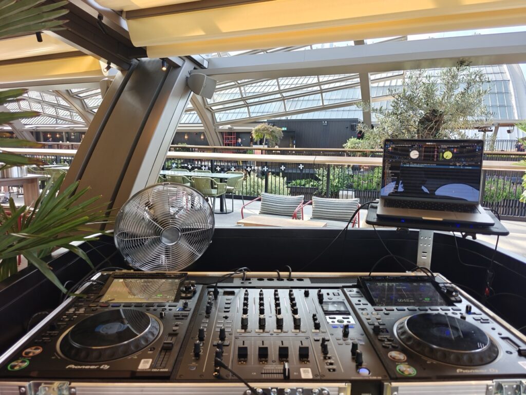 Bar Arriba DJ playing an open-format set at the rooftop bar, Olympia Kensington