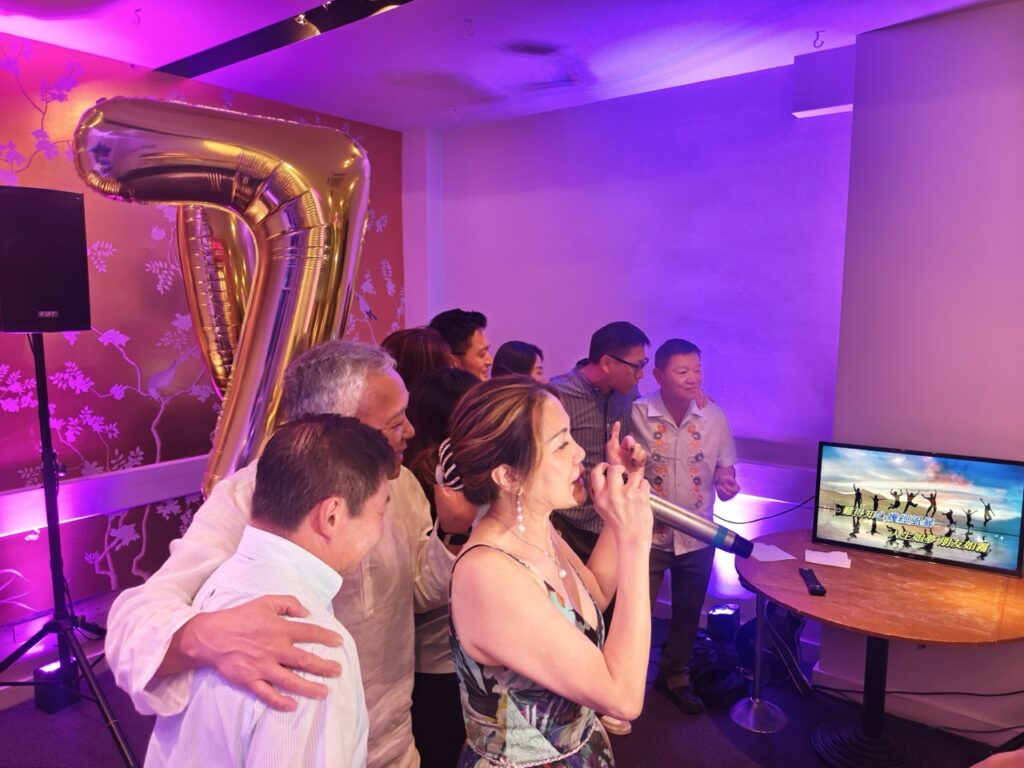 Guests singing at a 70th birthday karaoke party hosted by Party Night London